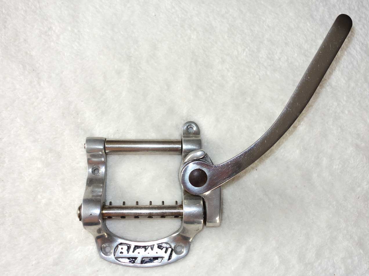 Vintage Bigsby B5 Tailpiece * IN STOCK *  Patent Number D 169120  w/Original Spring   Up for sale is a vintage Bigsby B5 tailpiece, complete with original spring. This is the Patent Number Bigsby B5 tailpiece, which I believe dates it to the 1960s. The unit functions fine, and has no issues.  Please check our OTHER LISTINGS for more vintage parts, unusual electrics, as well as * SOLD * for Pro Audio gear, Ameritage Guitar cases -- and we are actually the world's leading manufacturer of 10-String Classical Harp guitars, with over 500 guitars sold during the last 10+ years. Thanks for shopping with Cathedral Guitars!!!    